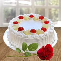 Attractive mouth watering Pineapple Cake with a Red Rose to Alwaye