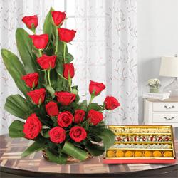 Bright charming 18 Red Roses and delicious mixed Sweets to Punalur