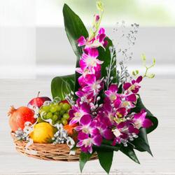Mouth-watering assorted Fruit basket with charming Flowers 