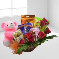 Irresistible Gift of Gourmets in Floral Basket with Teddy