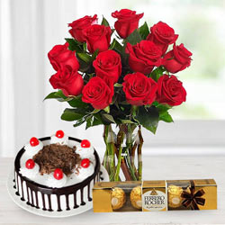 Stunning Bouquet of Red Roses with Ferrero Rocher and Black Forest Cake to Karunagapally