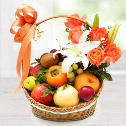 Decorative Imported Fruits Basket with Orange Roses n White Lily to Rajamundri