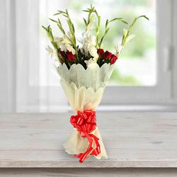 Beautiful Bouquet of Gladiolus N Roses in Tissue Wrap to Rajamundri