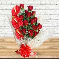 Amusing Red Roses N Anthurium Bouquet Wrapped in Tissue to Rajamundri