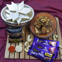 Pious Om Rakhi with Puja Tray, Haldiram Sweets N Cadbury Chocolates to Rakhi-to-world-wide.asp