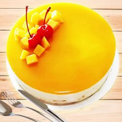 Scrumptious Eggless Mango Cake with Cherry N Mango Topping to Alwaye