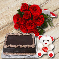 Delectable Chocolate Cake with Small Teddy N a Hand Bunch of Red Color Roses