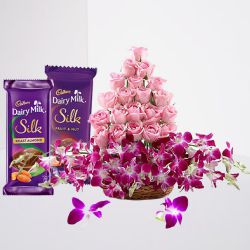 Lovely Pink Roses n Purple Orchids in Basket with Cadbury Silk Pair for Valentine	