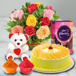 Nicely Gift Wrapped Mixed Roses Basket with Teddy Chocolate and Pineapple Cake 1 lb from Best Local Bakery with free Gulal/Abir Pouch.
.
