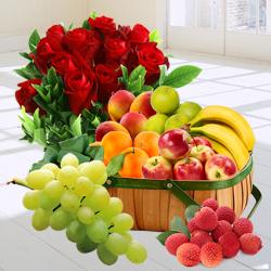 Bright Decadence Souvenir of Fresh Fruits in a Basket nd a Bouquet of Red Roses to Marmagao