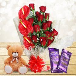 Mesmerizing Gift of Red Flowers Bouquet with Cute Teddy n Chocolates to Muvattupuzha