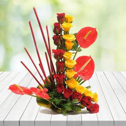 Exquisite Arrangement of Red N Yellow Roses with Anthurium to India