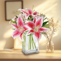 Mesmerizing Glass Vase display of Pink Lilies
 to Muvattupuzha