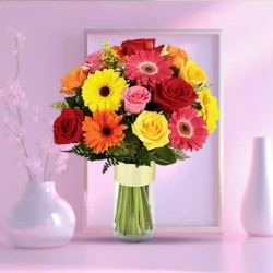 Multi-Hued Flowers arranged in a Glass Vase