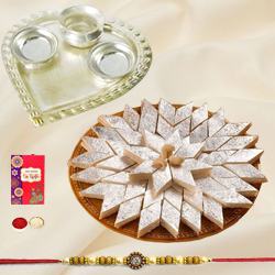 Delicious Haldiram Kaju Katli and Stylish and Trendy looking Silver Plated Paan Shaped Puja Aarti Thali (weight 52 gms) along Rakhi, Roli Tilak and Chawal