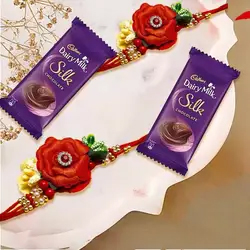 Enthralling Twin Flower Rakhi Set with Cadbury Dairy Milk Silk Chocolate Bar