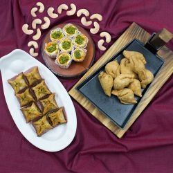 Tasty Pyramid Baklawa, Mini Samosa n Haldiram Kaju Pista Flower Gift Combo to Kollam