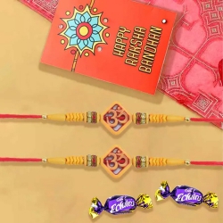 Gorgeous Pair of Om Rakhi with Chocolates, Roli Chawal Tika n Card to Rakhi-to-usa.asp