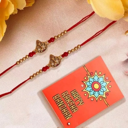 Flattering Pair of Ganesh Rakhi with Roli Chawal Tika n Card to Rakhi-to-usa.asp