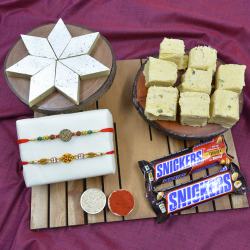 Pious Swastik Rakhi with Haldiram Sweets N Imported Snickers to Rakhi-to-world-wide.asp